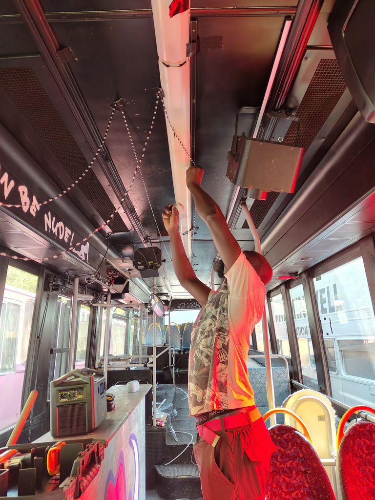 Junior working with LED lights inside a party bus