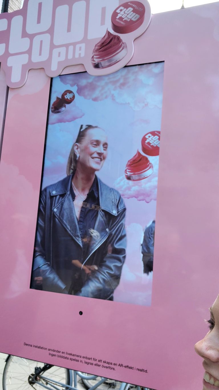 Person trying out an Augmented Reality display applying makeup