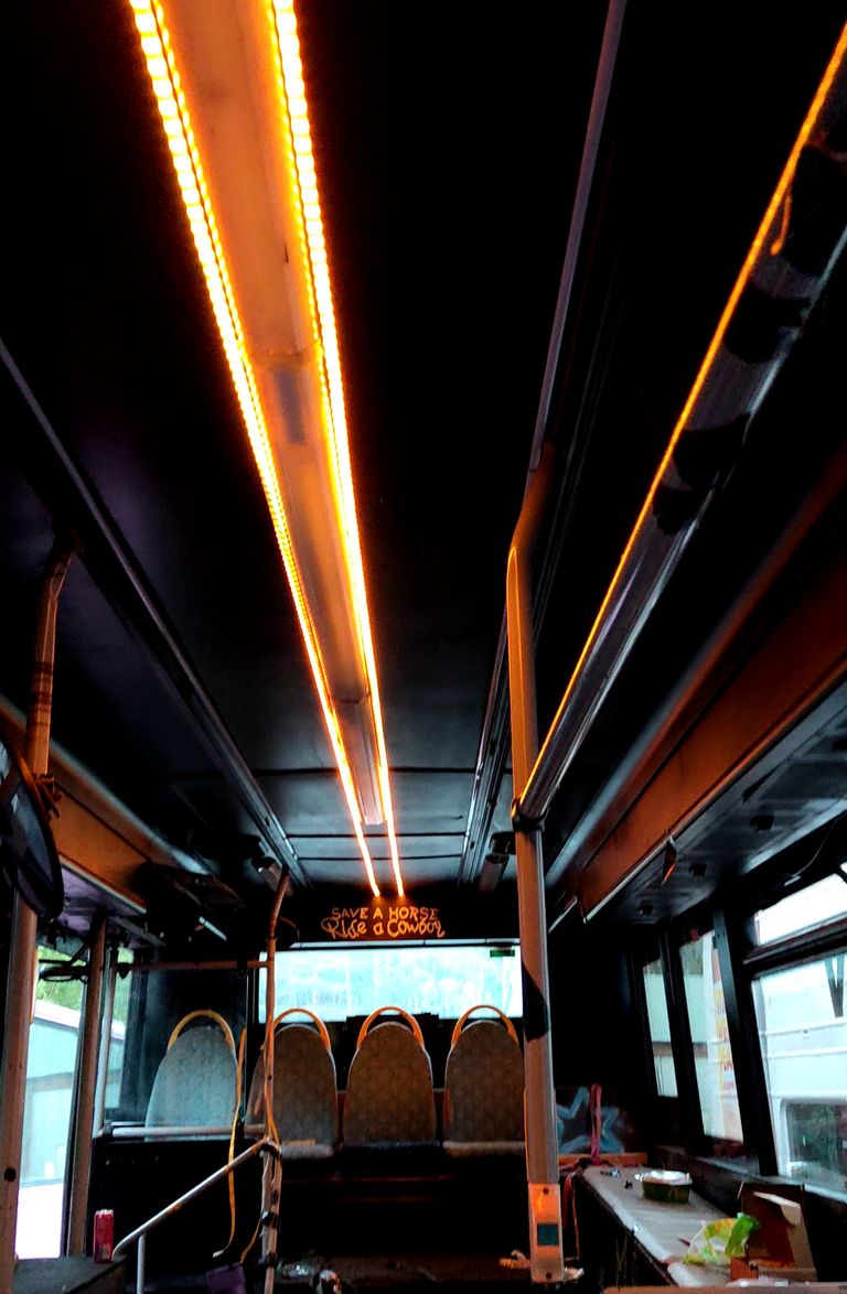 Orange LED light strips inside a bus